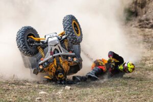 ATV operator in an accident where the ORV flipped over resulting in injury